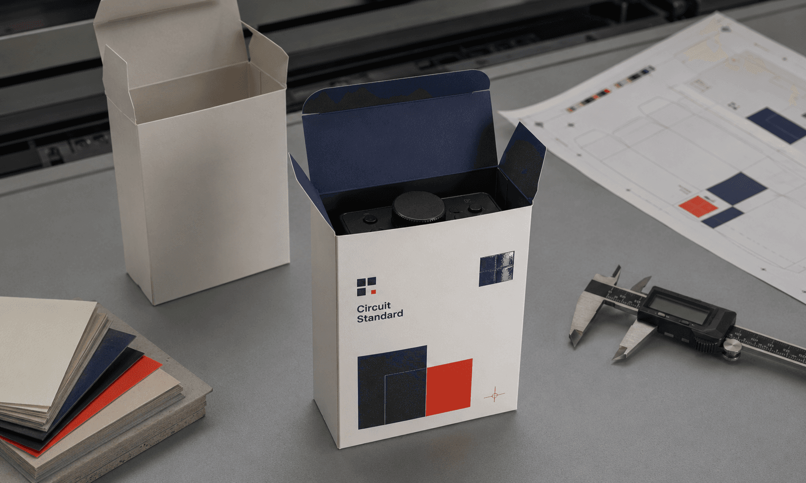 Packaging samples, calipers and board swatches arranged for a detailed supplier quality inspection.