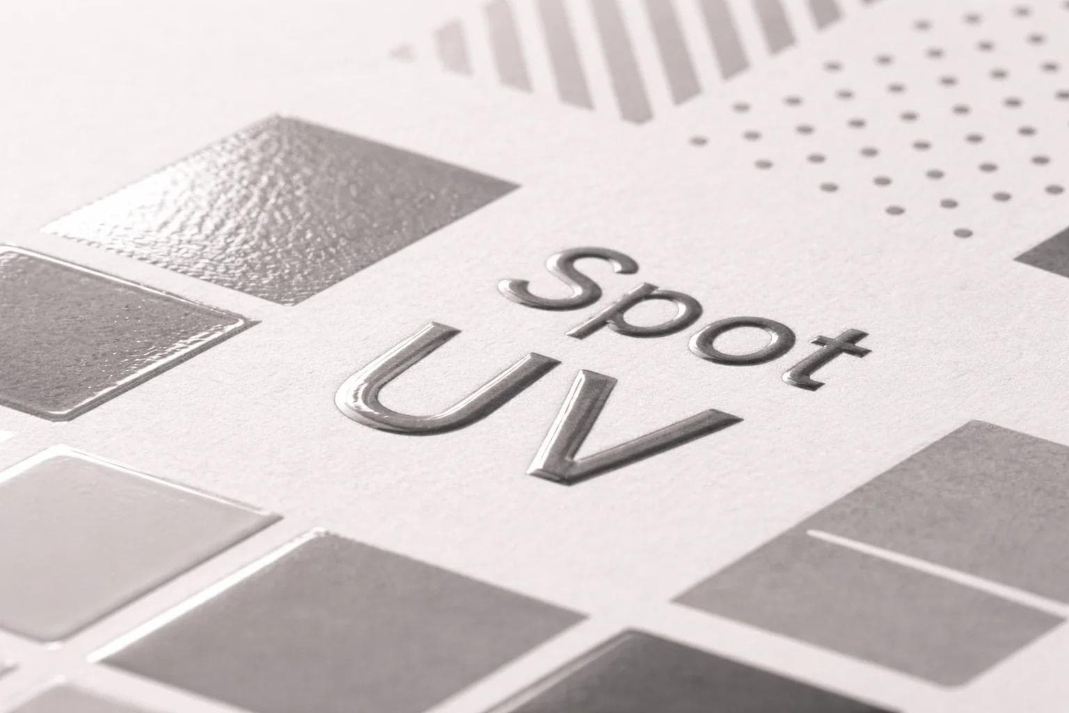 Macro close-up of selective spot UV and raised UV on printed packaging stock