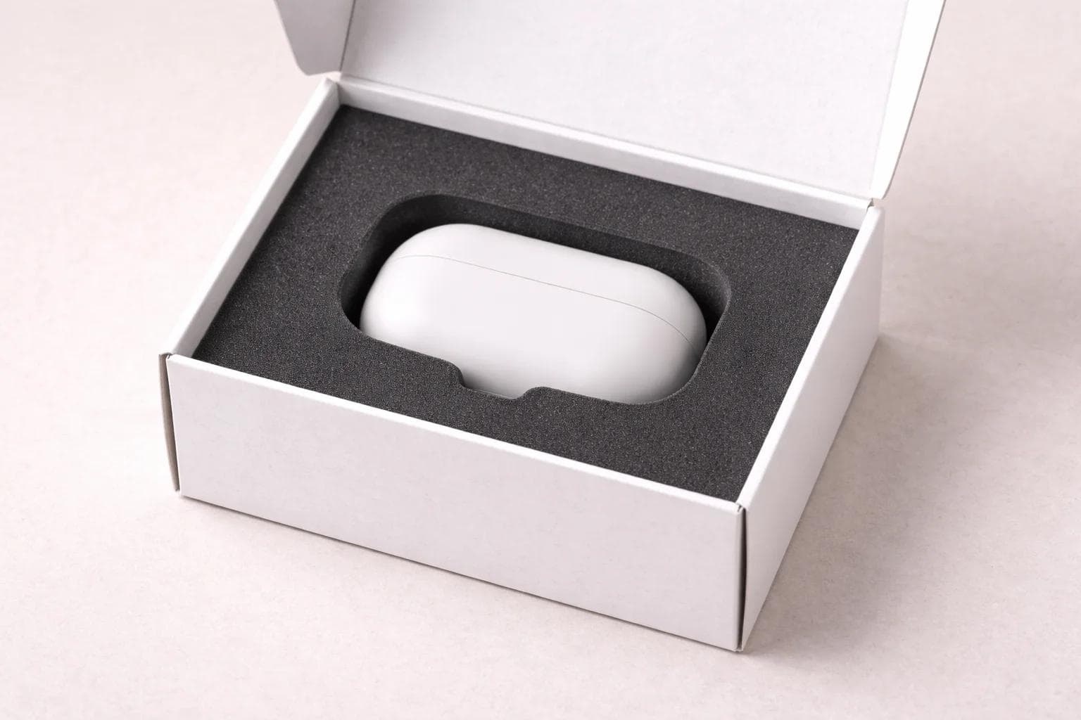 Open premium box with a custom-cut foam insert shaped around a product